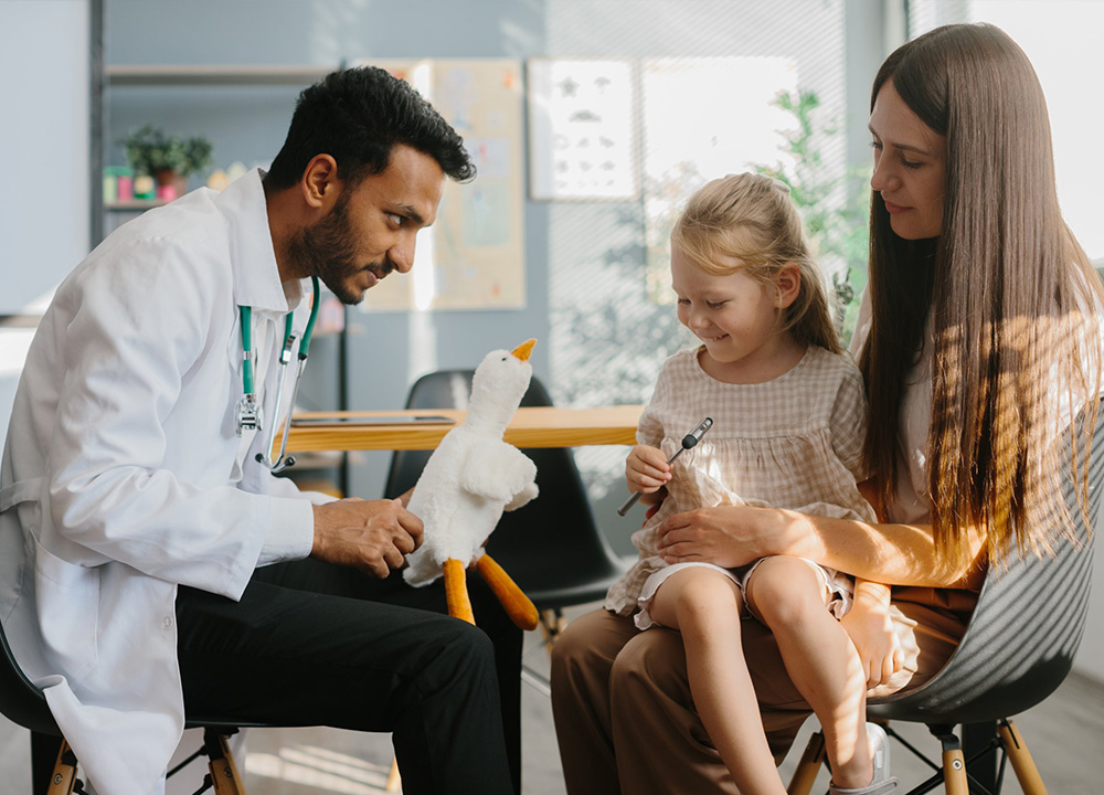A doctor speaking with a little girl patient